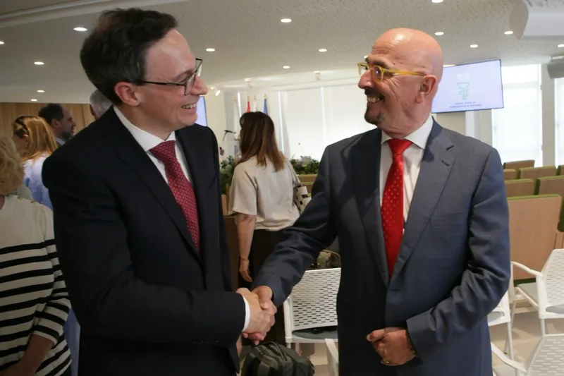 El consejero de Salud, César Pascual, saluda al nuevo presidente de la junta de Gobierno del Colegio de Farmacéuticos de Cantabria, José Daniel Carballeira, minutos antes de su toma de posesión hoy en la sede colegial (Foto: Nacho Romero)